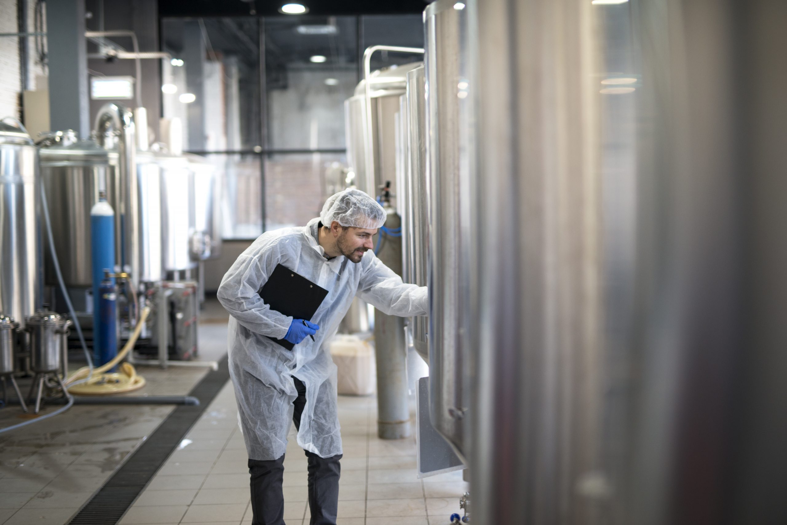 professional technologist controlling industrial process production plant scaled
